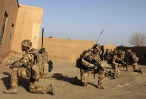British soldiers take defensive positions during a patrol in Qari Sahib, Nad Ali district in Helmand province