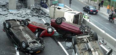 Vehicles that were driving along a highway that collapsed near Santiago are seen overturned on the asphalt Saturday, Feb. 27, 2010 after a powerful earthquake struck central Chile early Saturday. Vehicles that were driving along a highway that collapsed near Santiago are seen overturned on the asphalt Saturday, Feb. 27, 2010 after a powerful earthquake struck central Chile early Saturday.