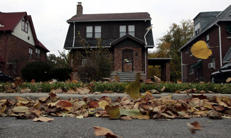 Fallen leaves blow past an empty home in Detroit