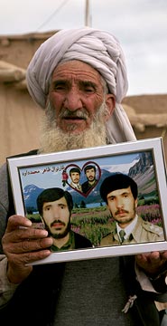 Haji Sharabuddin holds up a photo of his sons