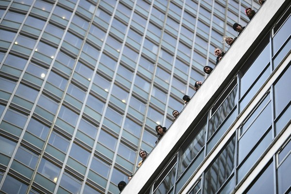 Students line the roof of Millbank after clashing with police during attempts to enter Millbank Tower home of Conservative Party headquarters in London. Student groups are protesting the government's proposed funding cuts to education and an increase in tuition fees.