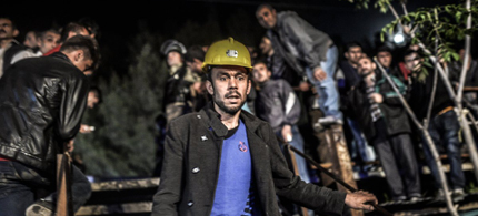 Miners wait at the gate of a mine after an explosion in Manisa on May 13, 2014. (photo: Bulent Kilic/AFP/Getty Images)