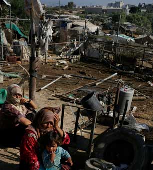 Women sit in their makeshift home in the Forgotten Neighborhood in Gaza City, Gaza, September 6, 2012. A United Nations report cites shortages of food, water, electricity, jobs, hospital beds and classrooms amid an exploding population in what is already one of the most densely populated patches of the planet. (Photo: Ed Ou / The New York Times) 
