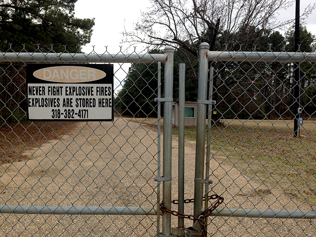 A locked gate and warning sign at the Camp Minden military facility near Minden, Louisiana. Fearing cancer-causing pollution, local residents are opposing an EPA plan to burn 15 million pounds of hazardous artillery munitions waste in open "burn trays" at Camp Minden. (Photo: Mike Ludwig)
