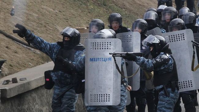 Riot police confronting protesters in Kiev