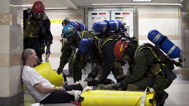 A mock victim is helped by emergency personnel during a biological preparedness drill being led by members of the Chemical Biological Incident Response Force (CBIRF), a unit in the US Marine Corps at Penn Station in New York City, September 22, 2012.