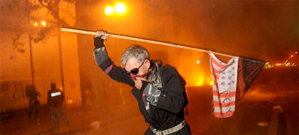 An Occupy Oakland protester runs from teargas. (photo: Noah Berger, AP)