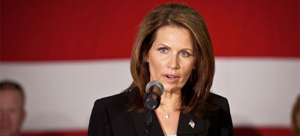 Michele Bachmann appears stunned as Occupy Charleston protesters using the human microphone technique interrupt her speech aboard the USS Yorktown in South Carolina, 11/11/11. (photo: Getty Images)