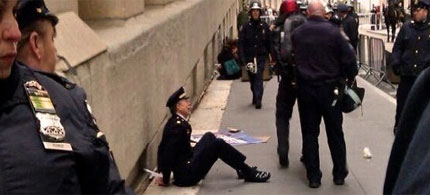 Retired Philadelphia Police Captain Ray Lewis, handcuffed, forced to sit on the ground, and arrested by New York City police, 11/17/11. (photo: Death and Taxes)