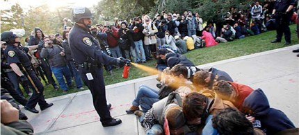 UC Davis Police Lt. John Pike uses pepper spray to move Occupy UC Davis protesters blocking a walkway in the quad on Friday, 11/18/11. (photo: Wayne Tilcock/Davis Enterprise)