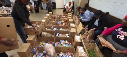 Members of the Georgia Avenue Food Cooperative pack boxes to distribute to the community, 01/10/12. (photo: Robert Johnson/CNN)