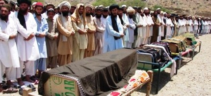 Pakistani villagers offer funeral prayers for people who were reportedly killed by a U.S. drone attack, 06/16/11. (photo: AP)