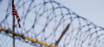 The flag and barbed wire within a detention facility at Guantanamo Bay. (photo: Getty Images)