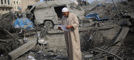 A man read a document on the grounds of the Hamas complex. (photo: Wissam Nassar/The New York Times)