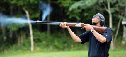 President Obama fires a rifle at Camp David. (photo: Pete Souza)