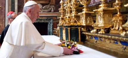 Pope Francis puts flowers on the altar inside St. Mary Major Basilica, 03/14/13. (photo: L'Osservatore Romano/AP)
