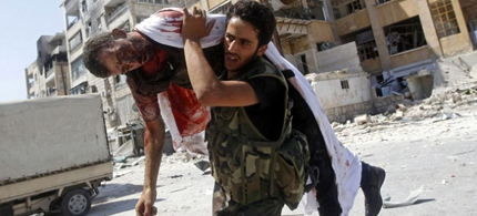 Free Syrian Army rebel trying to save his friend's life, November 2012. (photo: Reuters)