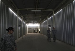  U.S. soldiers stand outside cells in this 2010 file photo at "Parwan Detention Facility" in Bagram north of Kabul, Afghanistan. 