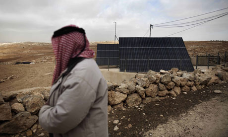 MDG : A Palestinian man looks at a solar panel in the southern West Bank village of Imneizil 