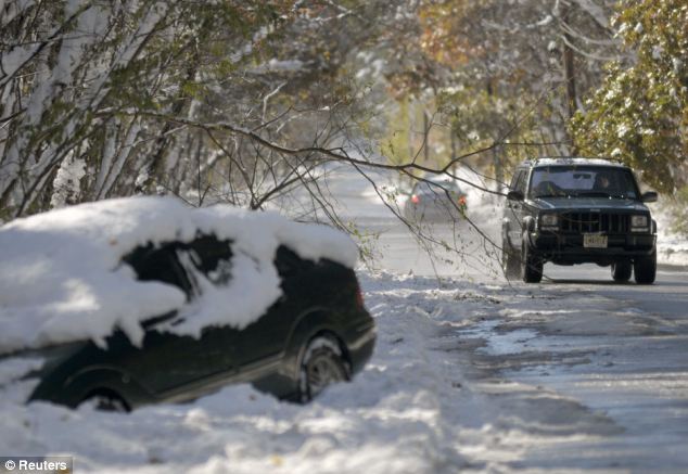 Accident: A jeep drives around a downed tree while another sits in a ditch on Union Valley Road, West Milford, New Jersey