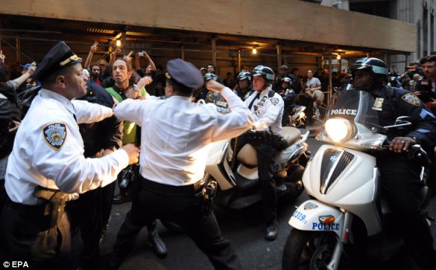 Force: New York City Police Department Inspector Cardona hits protester Felix Rivera (wearing a green shirt), as protesters clash with police