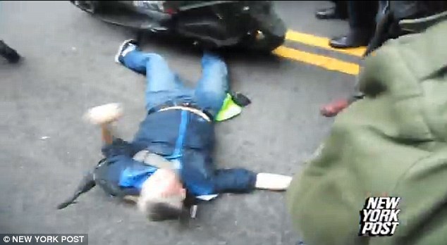 Trapped: Footage appears to show a police officer trap a protester's foot under his wheel