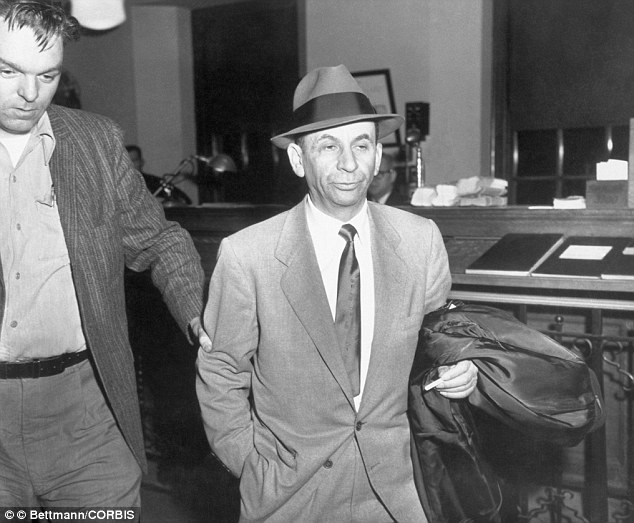 Booked: Gambling boss Meyer Lansky, right, smokes a cigarette as he is booked on charges of vagrancy at the West 54th Street police station in Manhattan in 1958