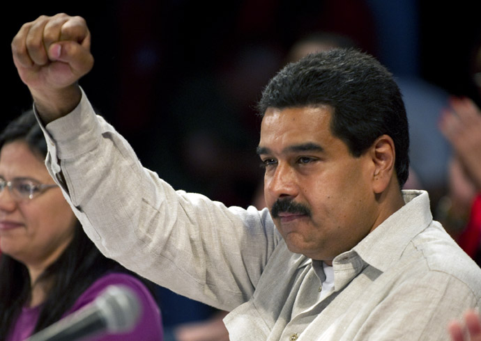 Venezuelan acting president Nicolas Maduro raises his clenched fist during a rally with leftist political parties in Caracas on March 20, 2013. (AFP Photo)