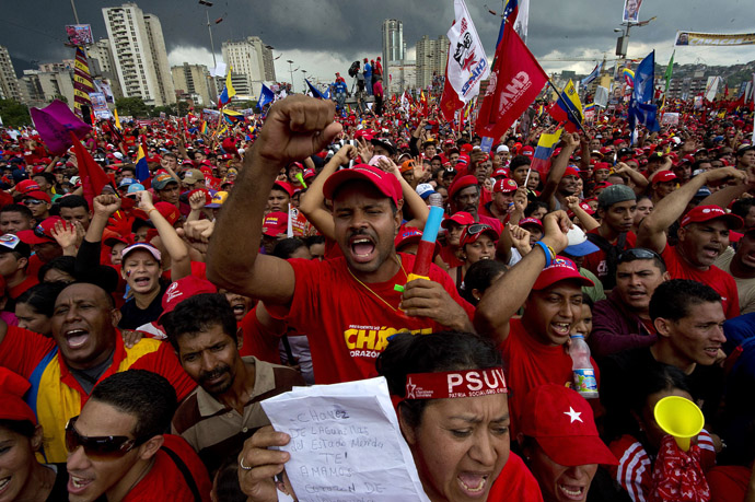 Supporters of Venezuelan President Hugo Chavez attend his campaign closure rally in Caracas, on October 4, 2012. (AFP Photo/Luis Acosta)