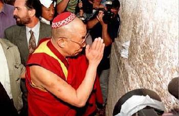 His holiness, the Dalai Lama, wearing a yarmulke as he prays at the Western Wall