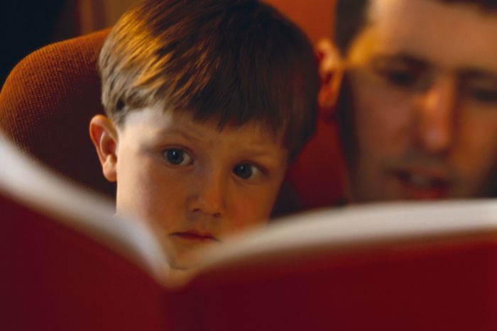 A child being read to by an adult