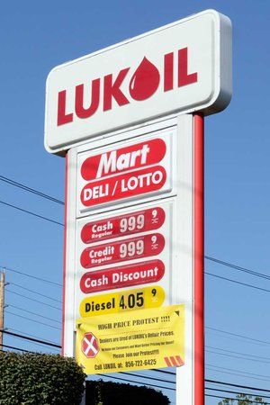 The LukOil gas station on Route 73 in Mount Laurel is charging $9.99 9/10 per gallon for regular gasoline September 12, 2012. Co-owner Kay Kezbari, not shown, is encouraging customers to purchase plus or super instead, as he taking part in a protest by some LukOil franchise stations in New Jersey and Pennsylvania against their parent company by posting ridiculously high prices today. Laws are strict about price changes at the pump, so if it says 9.99, that what it costs. One customer insisted on getting two gallons - 