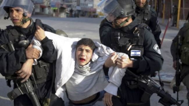 Israeli troops arrest a Palestinian youth at the Shuafat refugee camp in al-Quds in February 2010.