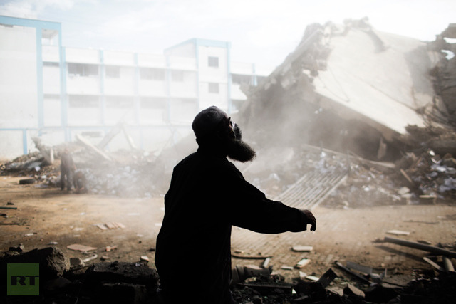 A Palestinian man helps clean the debris from the building of the Ministry of Interior in Gaza City on November 24, 2012, after it was destroyed during an Israeli air strike on November 16, at the height of the week-long conflict between Israel and Gaza militants (AFP Photo / Marco Longari) 