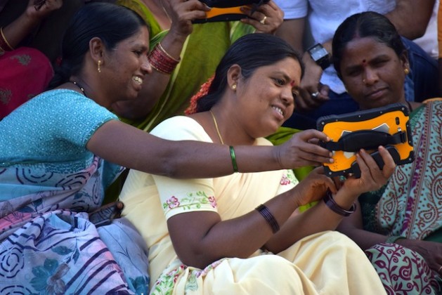 Members of a women-farmers collective demonstrate use of a devices that sends daily bulletins on weather patterns, crops and other matters of importance to farming communities in rural India. Credit: Stella Paul/IPS