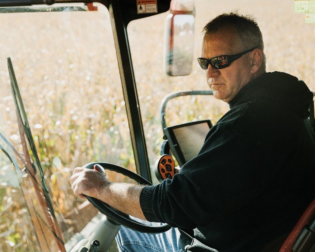 Huegerich, in his combine. He has no ideological problem with GMOs but has been experimenting with conventional seeds for financial reasons.
