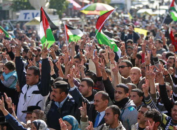 People wave Palestinian flags during a rally supporting the Palestinian UN bid for observer state status, in the West bank city of Ramallah, Thursday, Nov. 29, 2012.