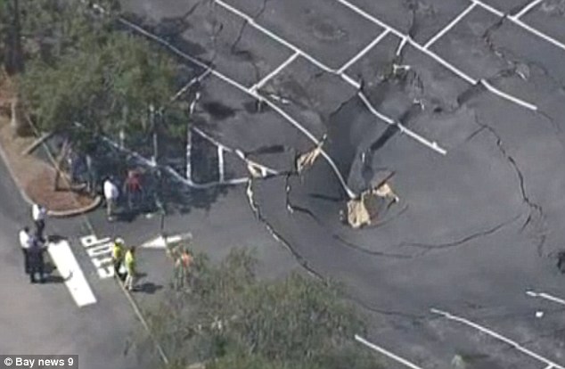 The sink hole is now believed to be 70 feet wide and 15 feet deep - consuming a large park of the parking lot of a Publix outside Tampa, Florida