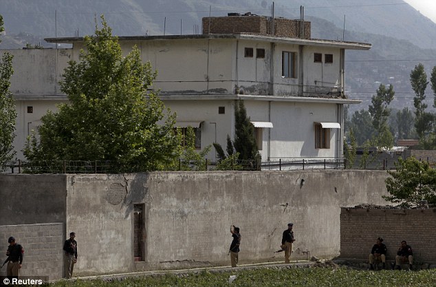Stronghold: Members of the anti-terrorism squad are seen surrounding the compound where bin Laden was killed by Navy SEAL Team 6 in Abbottabad May 4, 2011