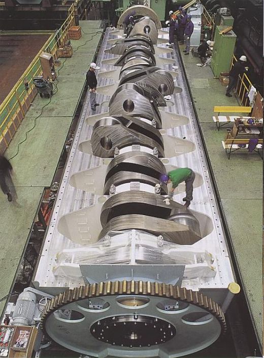 The crankshaft of worlds biggest engine  the crank shaft translates reciprocating linear piston motion into rotation. Compare its size with the size of the man.