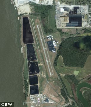Damage: Satellite images show the flooded General DeWitt Spain Airport five miles northwest of the central business district of Memphis, Tennessee