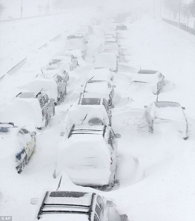 Blocked: Hundreds of cars are seen stranded on Lake Shore Drive, Chicago. Snow caused massive disruption to travellers at the start of the year